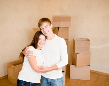 Professional movers carrying furniture through a London property