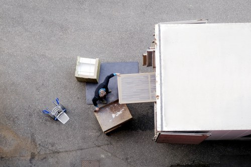 Professional packers organising moving boxes in a London home
