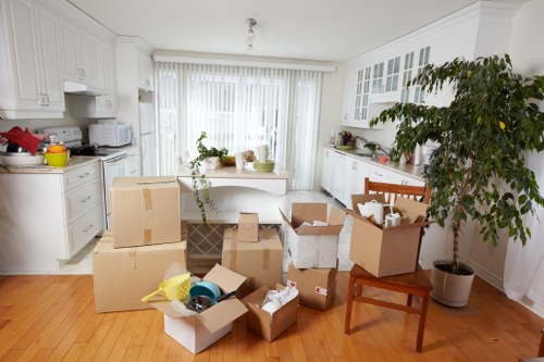 Team packing fragile household items for relocation in London