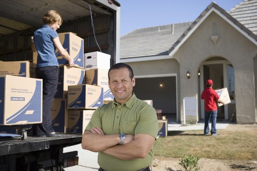 Loading furniture into a van during a London removal