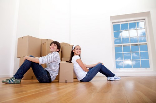 Professional movers loading household items for transport in London