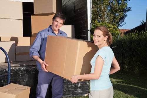 Removal team loading household items into a van in London