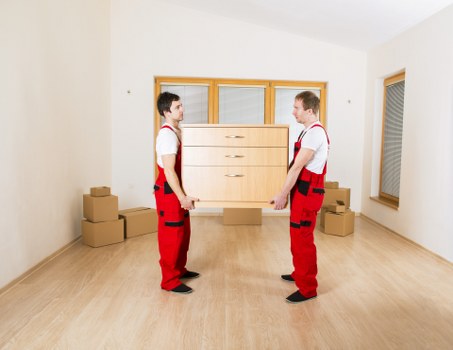 Local moving team loading furniture into a van